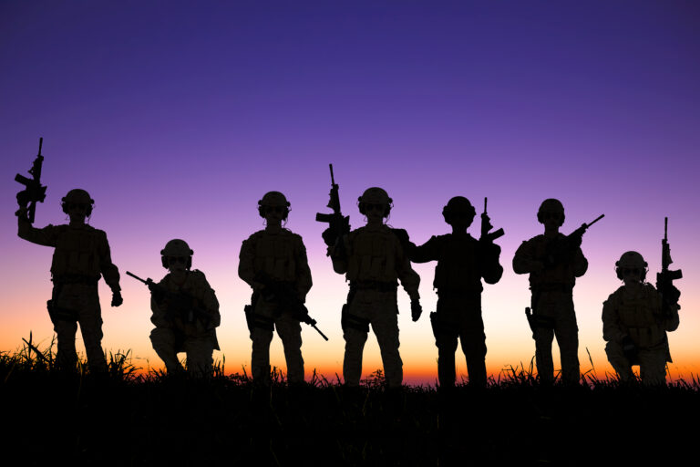 silhouette of Soldiers team with sunrise background.